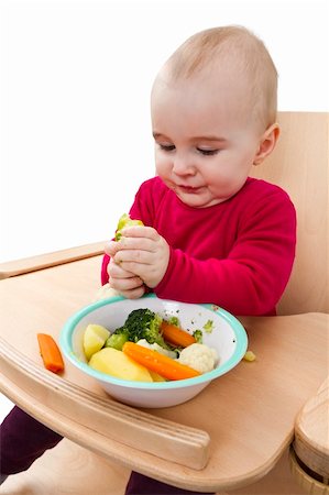 young child in red shirt eating vegetables in wooden chair. Stock Photo - Budget Royalty-Free & Subscription, Code: 400-06065287