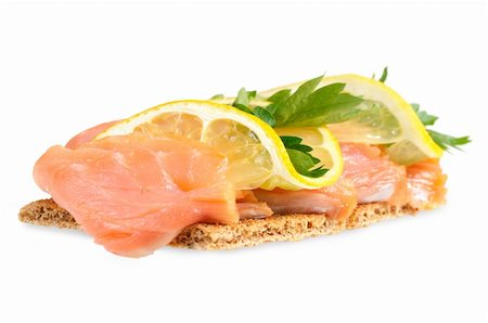 Sandwich snack - salmon with lemon on rye bread. Isolated on white. Stockbilder - Microstock & Abonnement, Bildnummer: 400-06065442