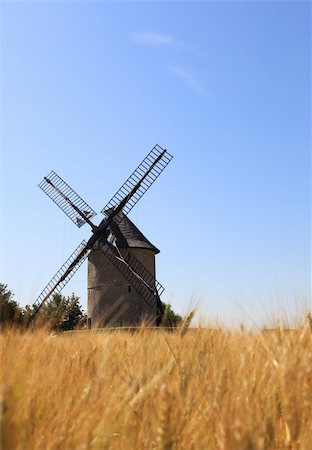 simsearch:400-06101286,k - Windmill in a wheat field.Selective focus in the distance on the windmill.The mill is Frouville Pensier in the Eure and Loir region of France. Stock Photo - Budget Royalty-Free & Subscription, Code: 400-06065585