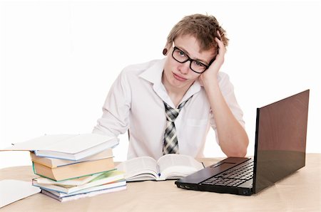 simsearch:400-04704759,k - frustrated student sits behind a desk isolated on white background Stock Photo - Budget Royalty-Free & Subscription, Code: 400-06065871