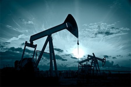 pumpjack - Oil and gas industry. Silhouette oil pumps on a sunset sky background. Toned. Stock Photo - Budget Royalty-Free & Subscription, Code: 400-06065894