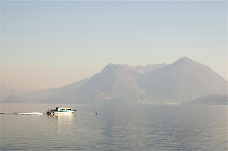 boat sailing to mountain lake Lago Magiore. Photographie de stock - Aubaine LD & Abonnement, Code: 400-06065962