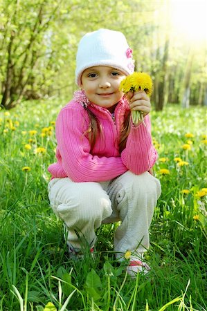 simsearch:400-06087517,k - Little girl is smelling dandelion in the field Stock Photo - Budget Royalty-Free & Subscription, Code: 400-06066177
