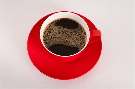 Red cup and saucer filled with black coffee on white background Fotografie stock - Microstock e Abbonamento, Codice: 400-06066187