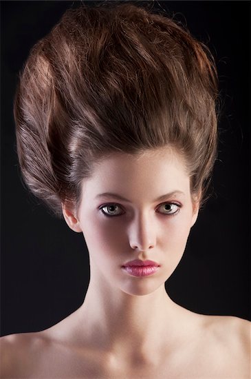 close up portrait of young beautiful woman with dark hair and creative hairstyle posing an black background Stock Photo - Royalty-Free, Artist: carlodapino, Image code: 400-06066662