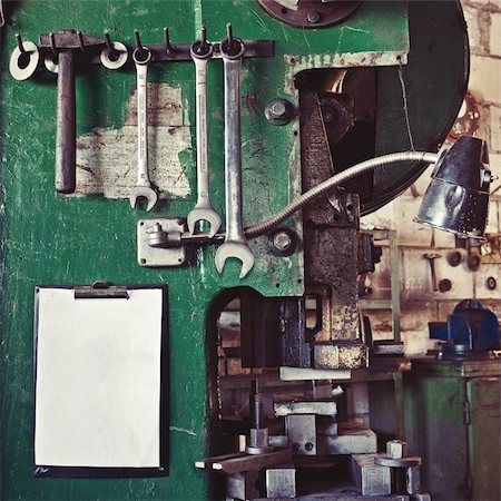 Assortment of various old tools hanging on a wall over workplace and a blank paper sheet as a copy space Stock Photo - Budget Royalty-Free & Subscription, Code: 400-06066732