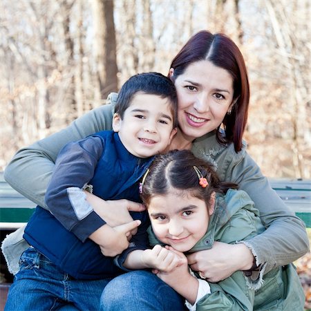 Family portrait of a smiling mother hugging a boy and girl. Stock Photo - Budget Royalty-Free & Subscription, Code: 400-06066797