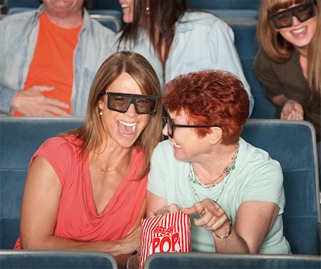 Groups of people in the audience with 3D glasses and laughing Stock Photo - Budget Royalty-Free & Subscription, Code: 400-06066859