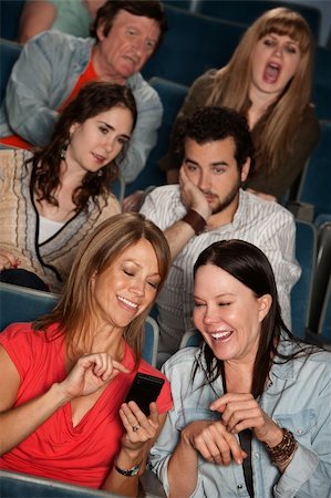 emotional disturbance males - Two women talking in theater with bothered audience Stock Photo - Budget Royalty-Free & Subscription, Code: 400-06066865