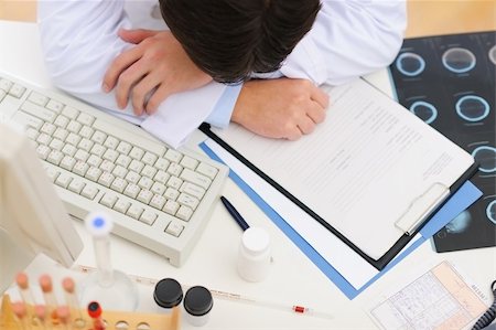 simsearch:400-04925813,k - Closeup on tired medical doctor sleeping on table Stock Photo - Budget Royalty-Free & Subscription, Code: 400-06067045