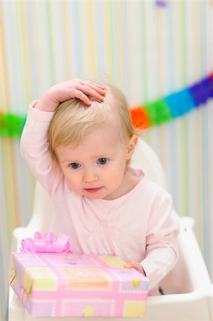 simsearch:400-06076022,k - Portrait of embarrassed baby celebrating first birthday Photographie de stock - Aubaine LD & Abonnement, Code: 400-06067057