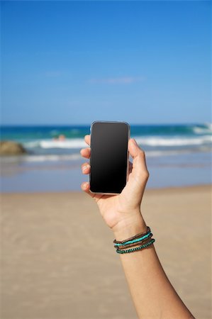 simsearch:400-06568351,k - smart phone in woman hand on a beach in Asturias Spain Stockbilder - Microstock & Abonnement, Bildnummer: 400-06067323