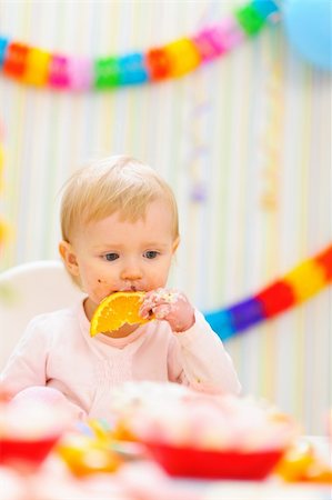 simsearch:400-06076022,k - Baby eating orange on first birthday celebration party Photographie de stock - Aubaine LD & Abonnement, Code: 400-06067364