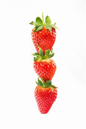 simsearch:400-03920561,k - A picture of three strawberries stacked on top of eachother Photographie de stock - Aubaine LD & Abonnement, Code: 400-06067485