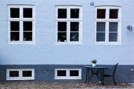 empty street wall - table and chair sitting on cobbled street outside pavement cafe in ebeltoft denmark Stock Photo - Budget Royalty-Free & Subscription, Code: 400-06068011