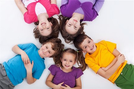 Five happy kids on the floor laying in circle Fotografie stock - Microstock e Abbonamento, Codice: 400-06068517