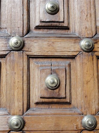 close up photo of a wooden door with brass studs Stock Photo - Budget Royalty-Free & Subscription, Code: 400-06068637