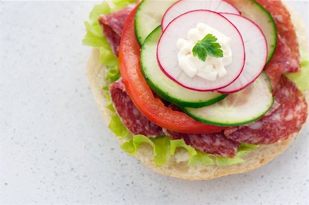 Delicious ham, cheese and salami sandwich with vegetables, lettuce, cherry tomatoes Foto de stock - Super Valor sin royalties y Suscripción, Código: 400-06068648