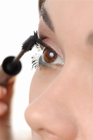 closeup of young brown eyed lady applying mascara using lash brush Stock Photo - Budget Royalty-Free & Subscription, Code: 400-06068888