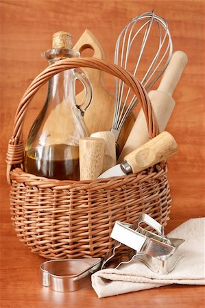 Wooden cooking utensils and jar of olive oil in a wicker basket. Stock Photo - Budget Royalty-Free & Subscription, Code: 400-06069433