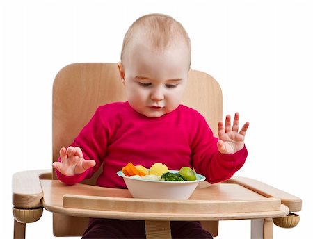 young child in red shirt eating vegetables in wooden chair. Stock Photo - Budget Royalty-Free & Subscription, Code: 400-06069876