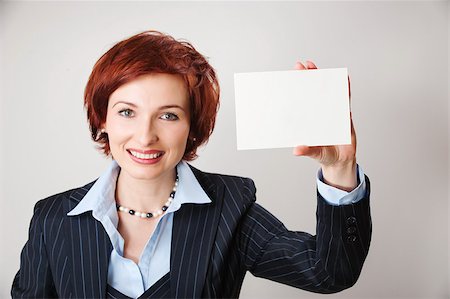 Woman holds out business card. Focus on hand and card Stock Photo - Budget Royalty-Free & Subscription, Code: 400-06060056