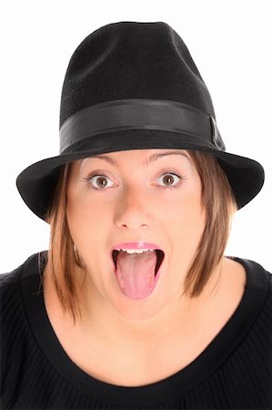 simsearch:400-06132090,k - A portrait of a pretty young woman in a black hat sticking out tongue over white background Photographie de stock - Aubaine LD & Abonnement, Code: 400-06060714