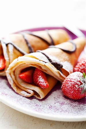 sweet thin french style crepes, served with strawberries,chocolate sauce and castor sugar, very close up and very shallow dof for a dreamy effect, focus on the strawberry in front Stock Photo - Budget Royalty-Free & Subscription, Code: 400-06060996