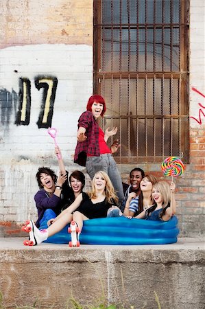 Crazy teen punks sit together in an inflatable pool behind an old warehouse downtown. Photographie de stock - Aubaine LD & Abonnement, Code: 400-06061748