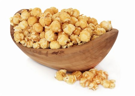 Butterscotch popcorn in an olive wood bowl and loose over white background. Stock Photo - Budget Royalty-Free & Subscription, Code: 400-06061819