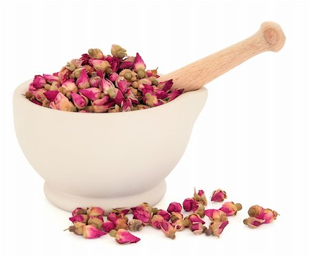simsearch:400-07174356,k - Rosebud flowers used in traditional chinese herbal medicine and the cosmetic industry in a stone mortar with pestle over white background. Stock Photo - Budget Royalty-Free & Subscription, Code: 400-06061921