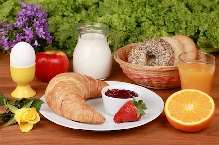 eggs milk - French breakfast with a croissant and strawberry jam. Served with milk, orange juice, egg, apple, bagels and flowers. Stock Photo - Budget Royalty-Free & Subscription, Code: 400-06062305
