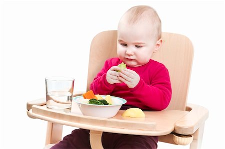 young child in red shirt eating vegetables in wooden high chair. Stock Photo - Budget Royalty-Free & Subscription, Code: 400-06062422