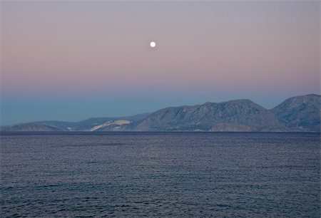 The moon rose above the sea. It was evening. The sky was painted in fanciful colors. Stock Photo - Budget Royalty-Free & Subscription, Code: 400-06062442