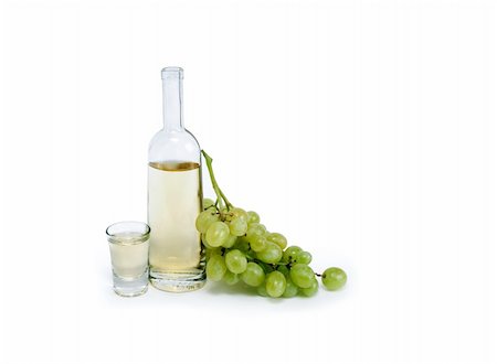 Open bottle of grappa near wineglass and bunch of grapes on white background. Clipping path is included Stock Photo - Budget Royalty-Free & Subscription, Code: 400-06062639