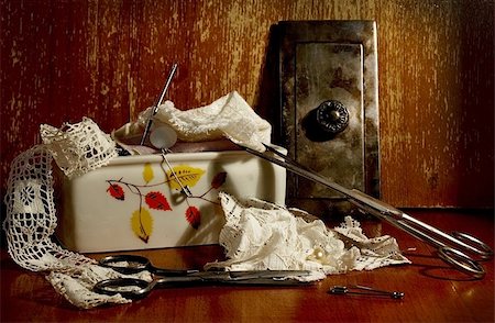 Still life with scissors, pins and laces on the background of the old wooden wall Stock Photo - Budget Royalty-Free & Subscription, Code: 400-06062644