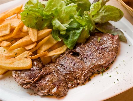 steak and fries - juicy steak beef meat with tomato and french fries Photographie de stock - Aubaine LD & Abonnement, Code: 400-06062900