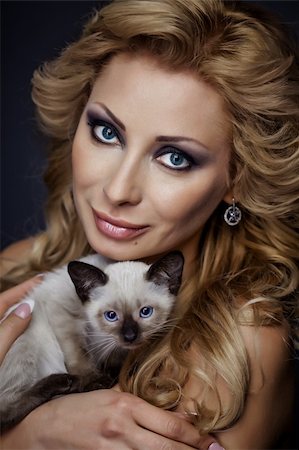 Portrait of a young sexy girl with kitten Stock Photo - Budget Royalty-Free & Subscription, Code: 400-06063077