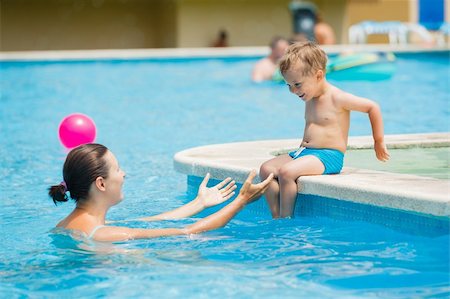 Cute boy with his mother playing in a pool of water during the summer Stock Photo - Budget Royalty-Free & Subscription, Code: 400-06063103