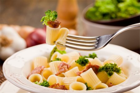 photo of delicious pasta with sausage and broccoli on wooden table Stockbilder - Microstock & Abonnement, Bildnummer: 400-06063254