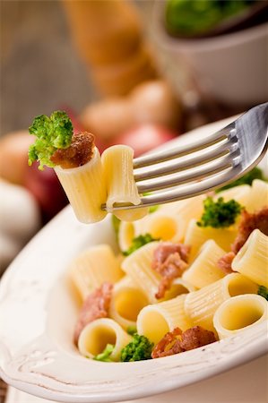 photo of delicious pasta with sausage and broccoli on wooden table Stockbilder - Microstock & Abonnement, Bildnummer: 400-06063255