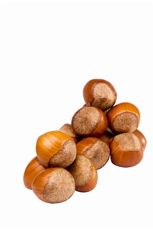 simsearch:400-06520688,k - Few hazelnuts and a pile of hazelnuts in the background on white. Stock Photo - Budget Royalty-Free & Subscription, Code: 400-06063455