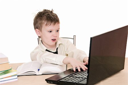 a boy pupil works on the laptop Stock Photo - Budget Royalty-Free & Subscription, Code: 400-06063548