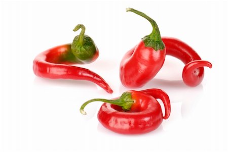 curved red chilli peppers isolated on white Photographie de stock - Aubaine LD & Abonnement, Code: 400-06063602