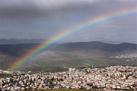 rainbow over the Arab village of Cana in the Galilee region of Israel. Foto de stock - Super Valor sin royalties y Suscripción, Código: 400-06063627