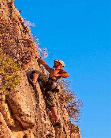climber while climbing a vertical rock wall Stockbilder - Microstock & Abonnement, Bildnummer: 400-06063899