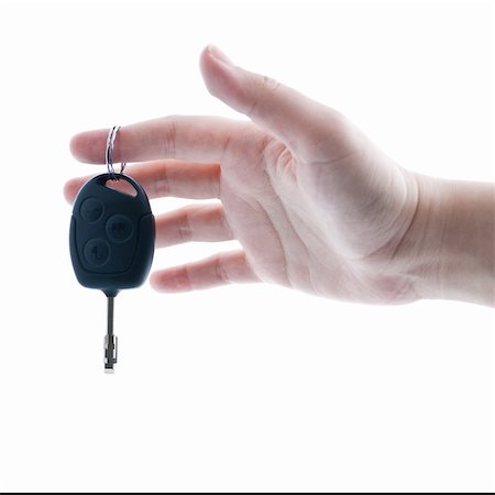 Woman's hand giving key from modern car. Isolated on white background. Stock Photo - Budget Royalty-Free & Subscription, Code: 400-06074090