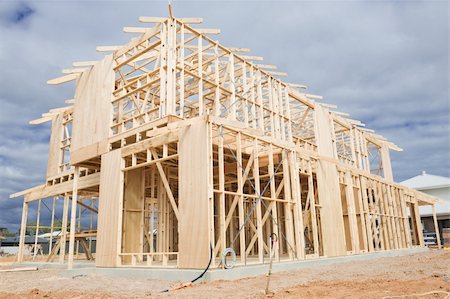 simsearch:400-06173250,k - New residential construction home wooden framing against a blue sky Foto de stock - Royalty-Free Super Valor e Assinatura, Número: 400-06074946