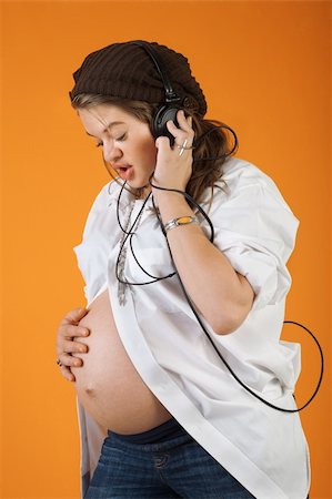 Pregnant woman with headphones singing to her baby Stock Photo - Budget Royalty-Free & Subscription, Code: 400-06075197