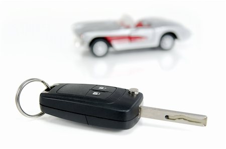 A car key isolated on white background with a car toy Stock Photo - Budget Royalty-Free & Subscription, Code: 400-06075293